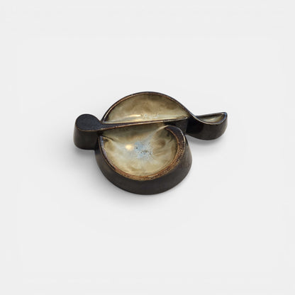 Two-tone brown-and-beige mid-century modern pottery dish marked