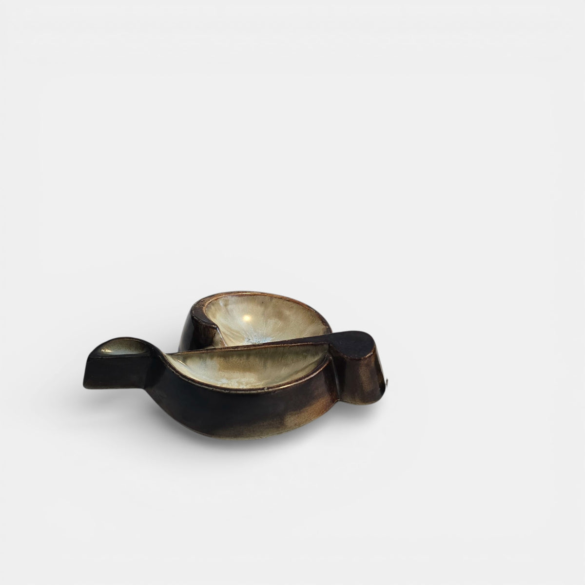 Two-tone brown-and-beige mid-century modern pottery dish marked