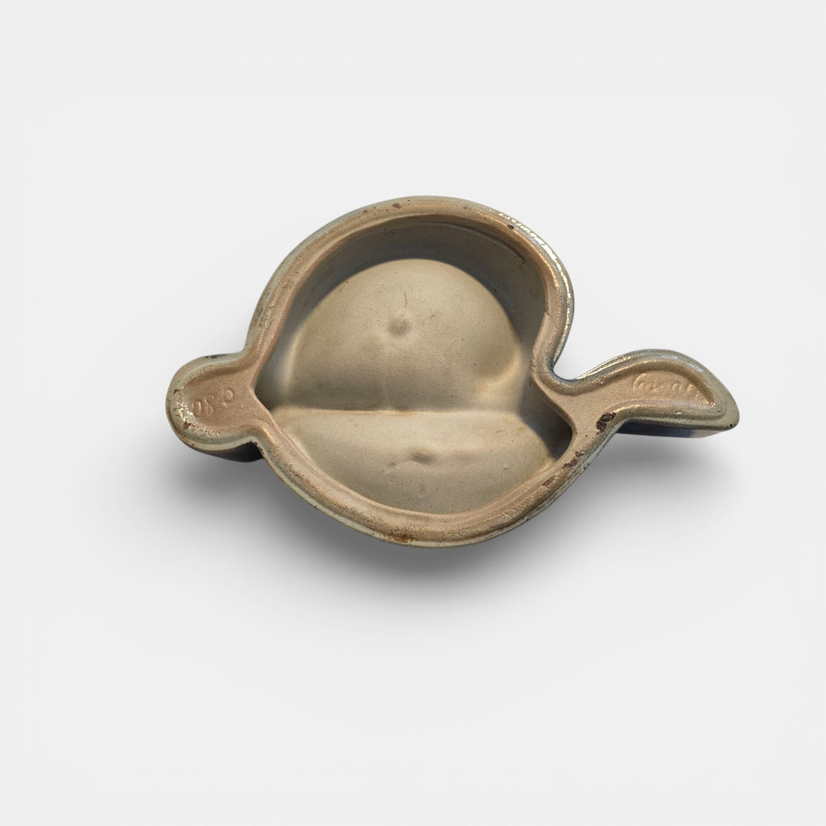 Two-tone brown-and-beige mid-century modern pottery dish marked