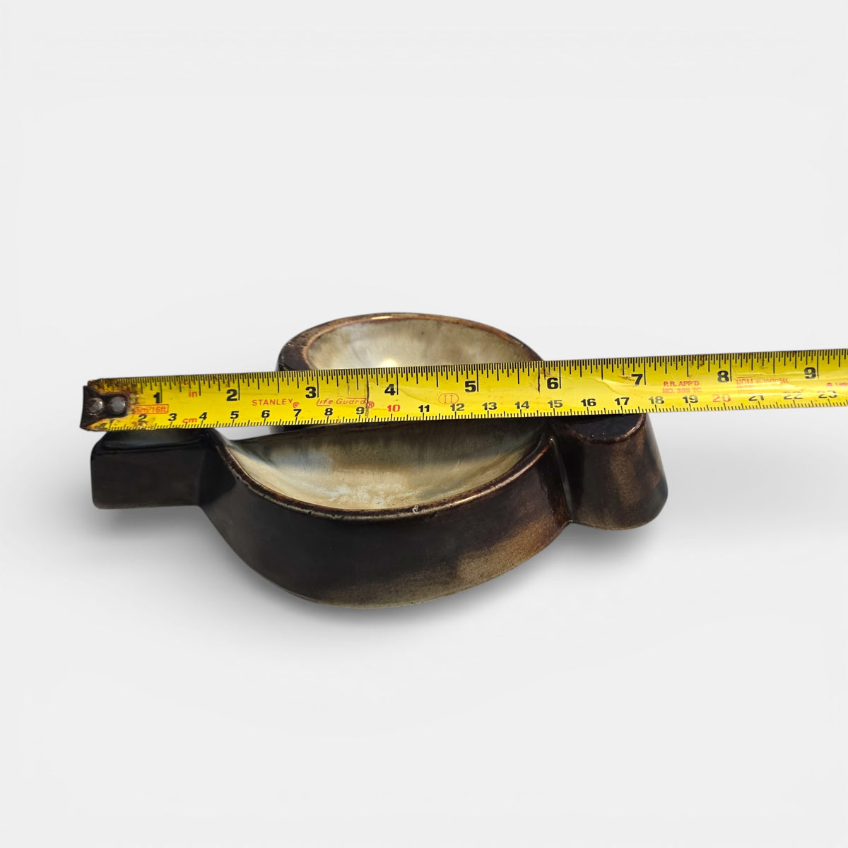 Two-tone brown-and-beige mid-century modern pottery dish marked